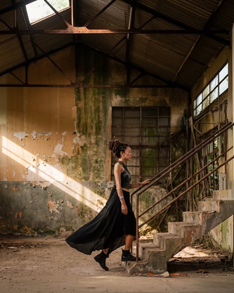 PANUH RITO: a figure crossing a ruined factory hall in a shaft of light.