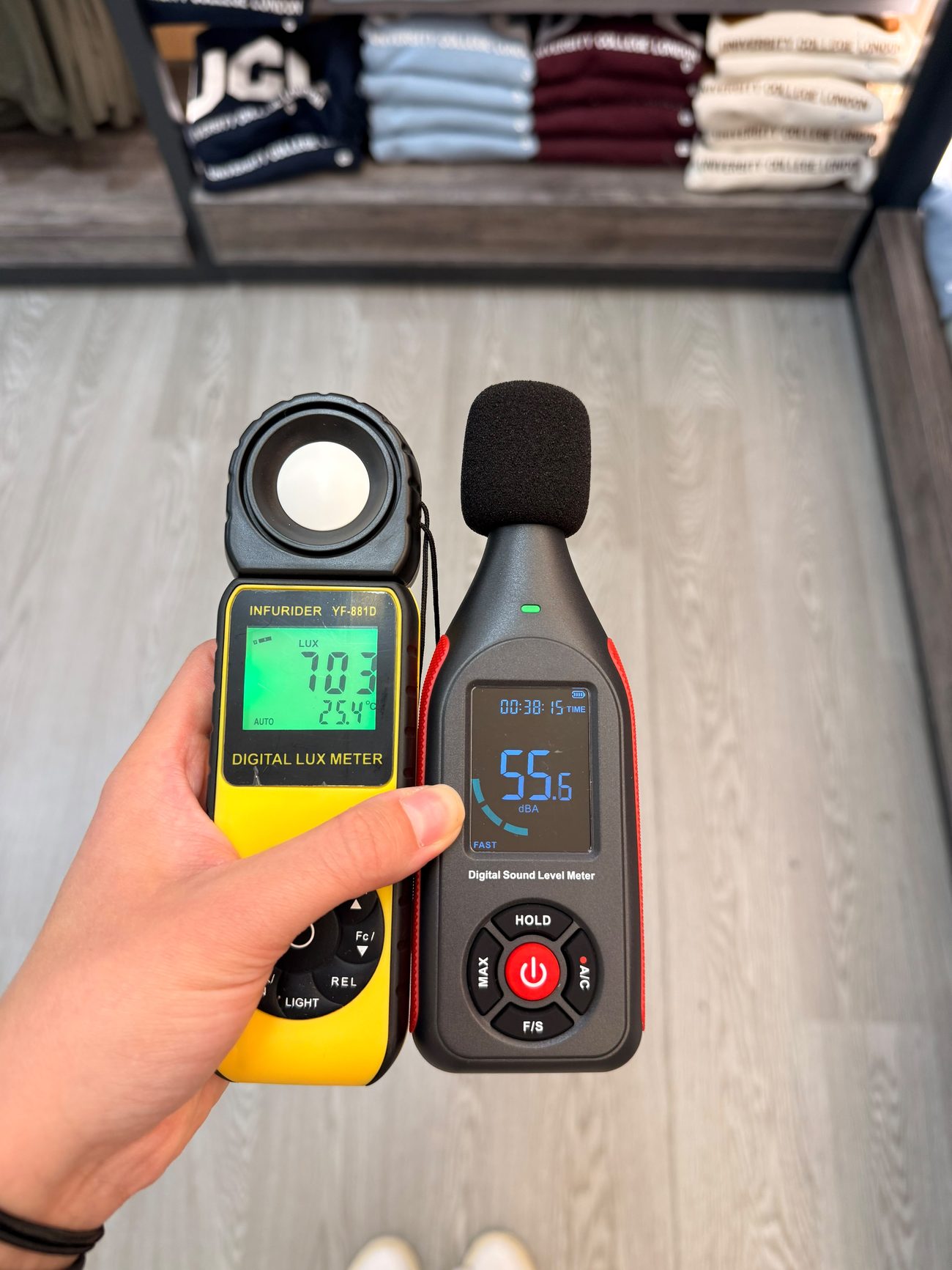 Lux meter and sound level meter in hand, inside the store.